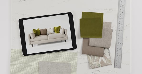 A tablet displays an image of a beige sofa with green and beige cushions. Next to the tablet are fabric swatches in green, beige, and grey, suggesting a design or customization process being aided by digital 3D visualization tools.